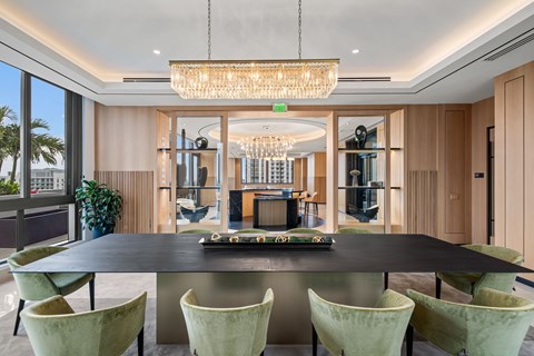 A modern dining room with a large table and chairs.