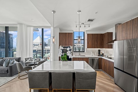 A modern kitchen with a dining table and chairs.