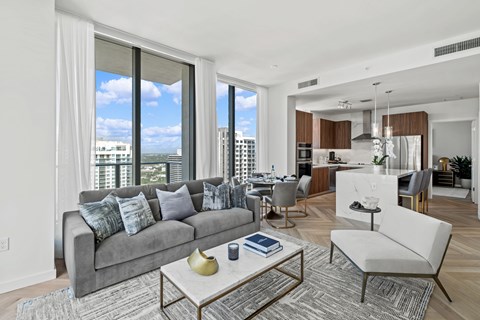 A modern living room with a grey sofa and a coffee table.
