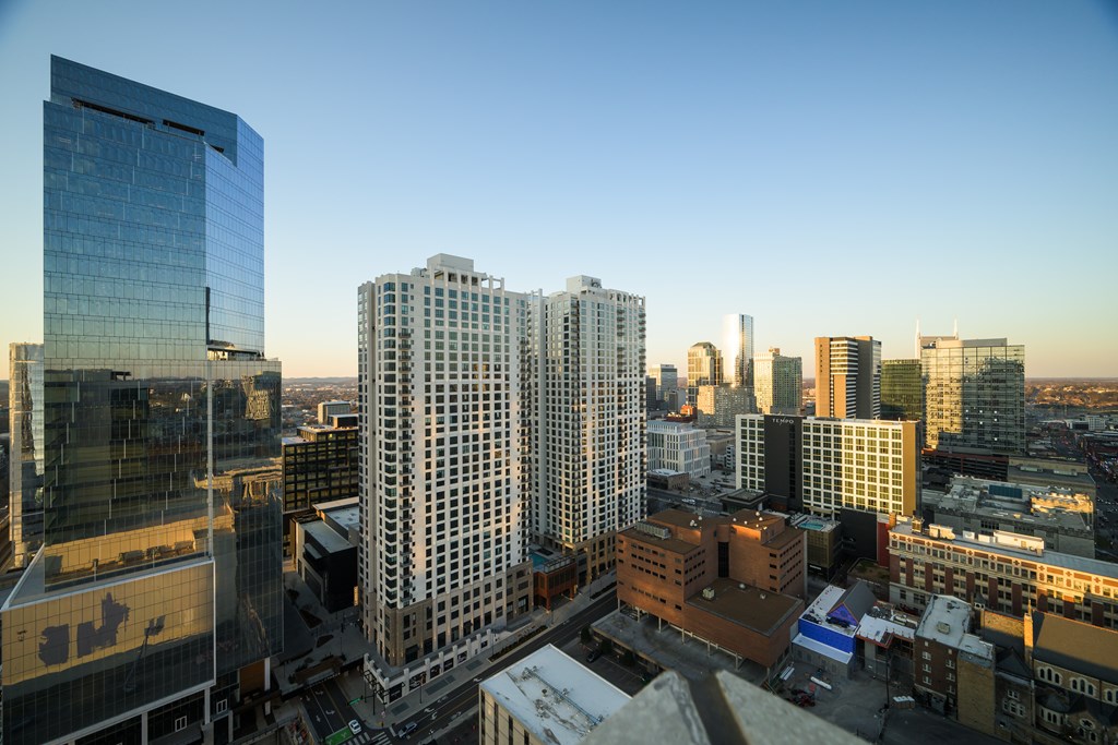 A cityscape with tall buildings and a clear sky.