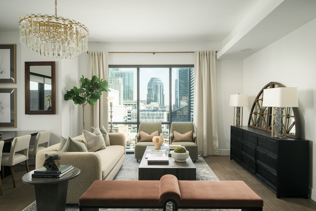 A living room with a large window overlooking a cityscape.