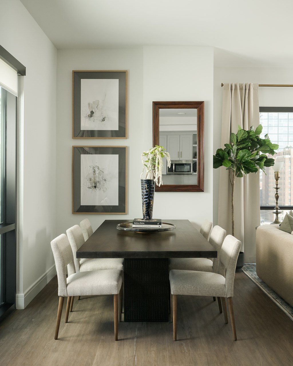 A dining room with a table and chairs.
