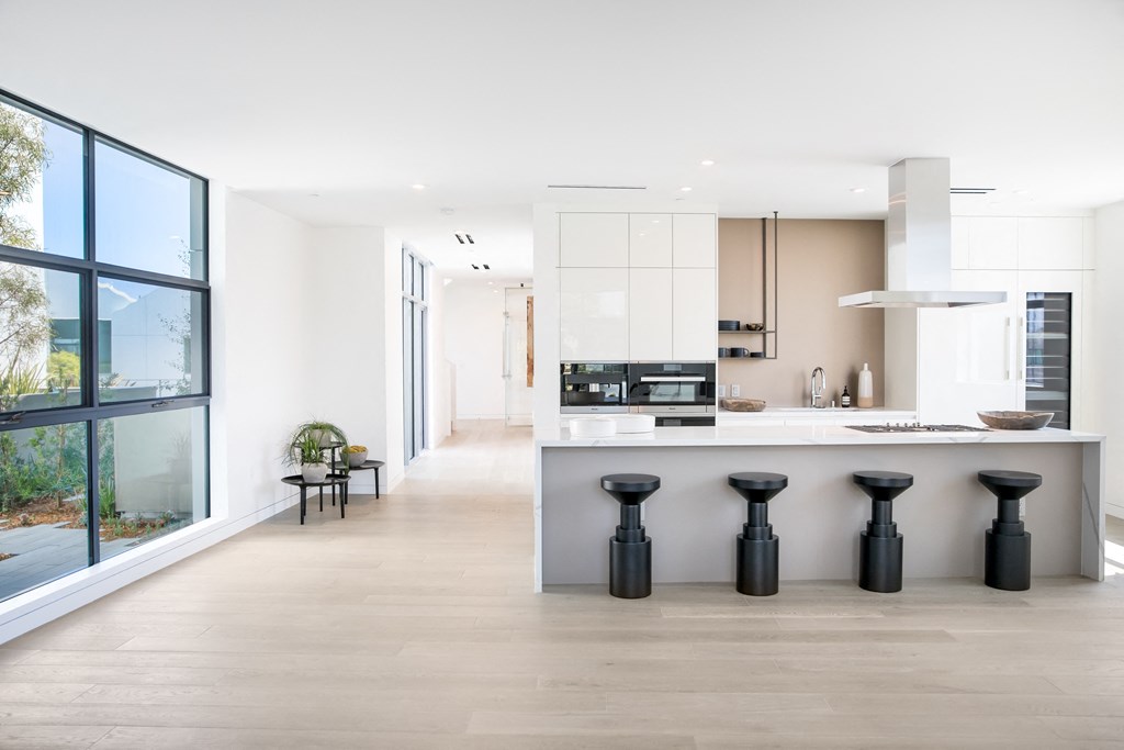 open kitchen with white cabinets and grey island