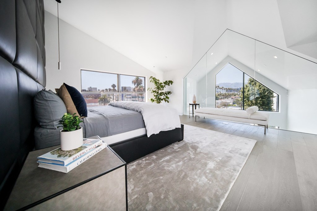 a bedroom with a large bed and a large window