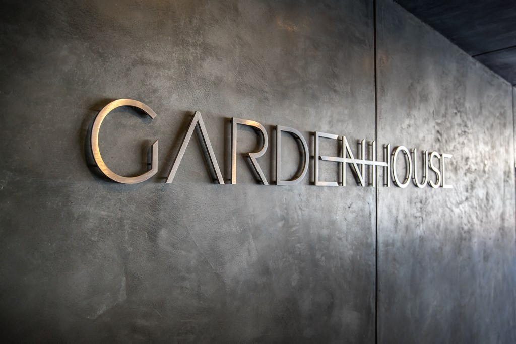 a metal sign that reads garden house on the side of a building