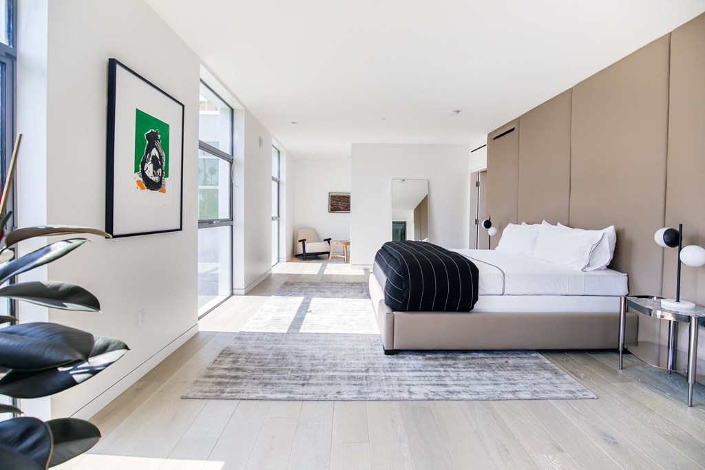 deep bedroom with floor to ceiling windows