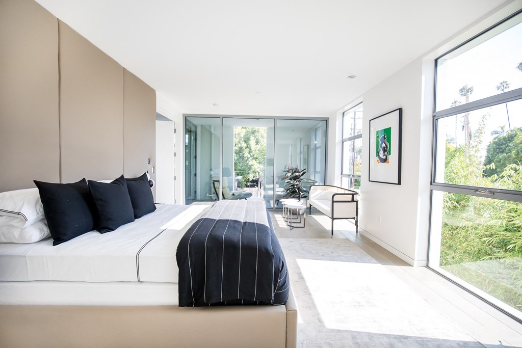 bright and spacious bedroom with floor to ceiling windows