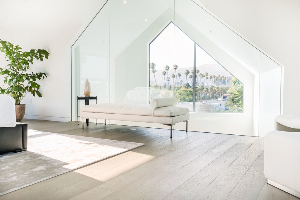 a white living room with a large window