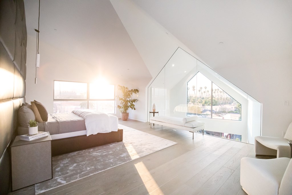 a bedroom with a bed and a window