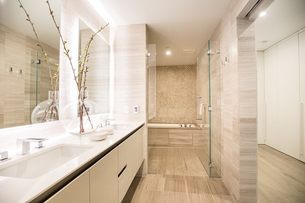a bathroom with a large shower and two sinks