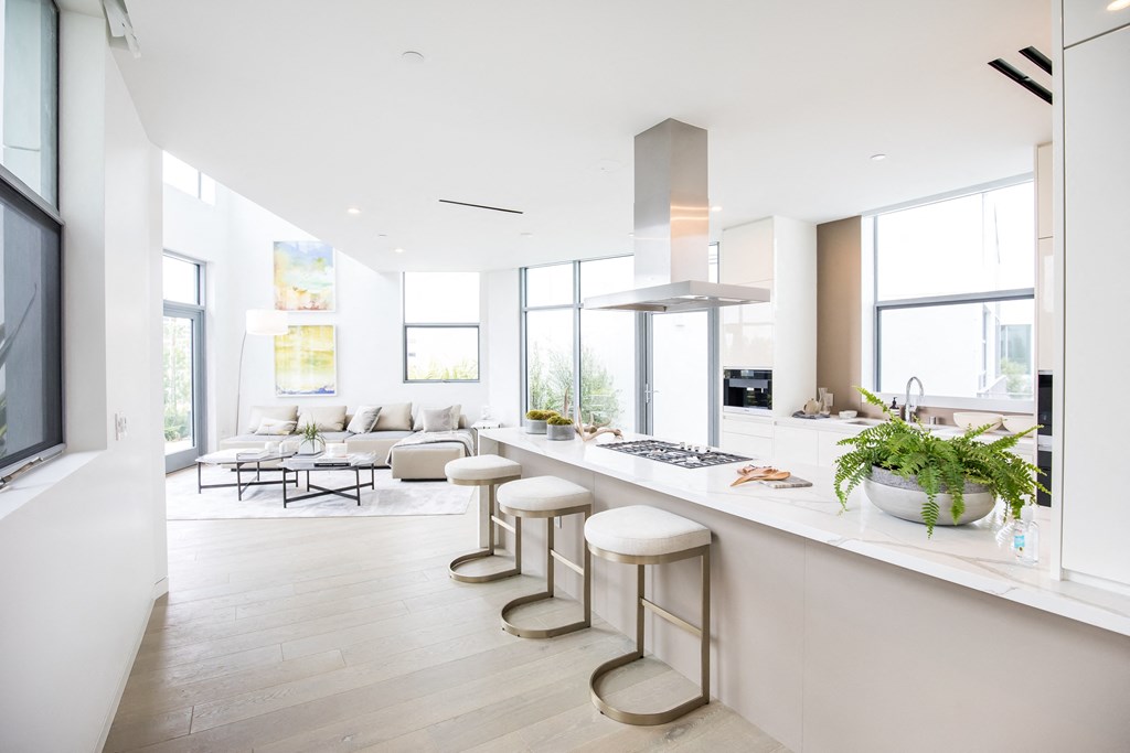 a kitchen with a long counter and stools in front of it