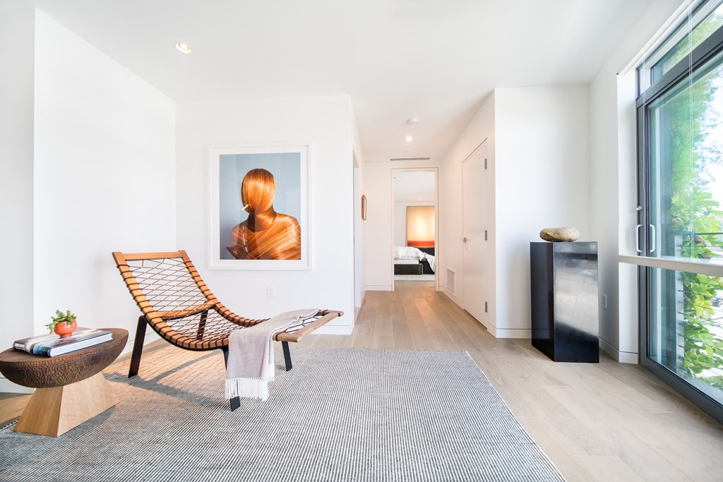 a living room with a chair and a painting on the wall