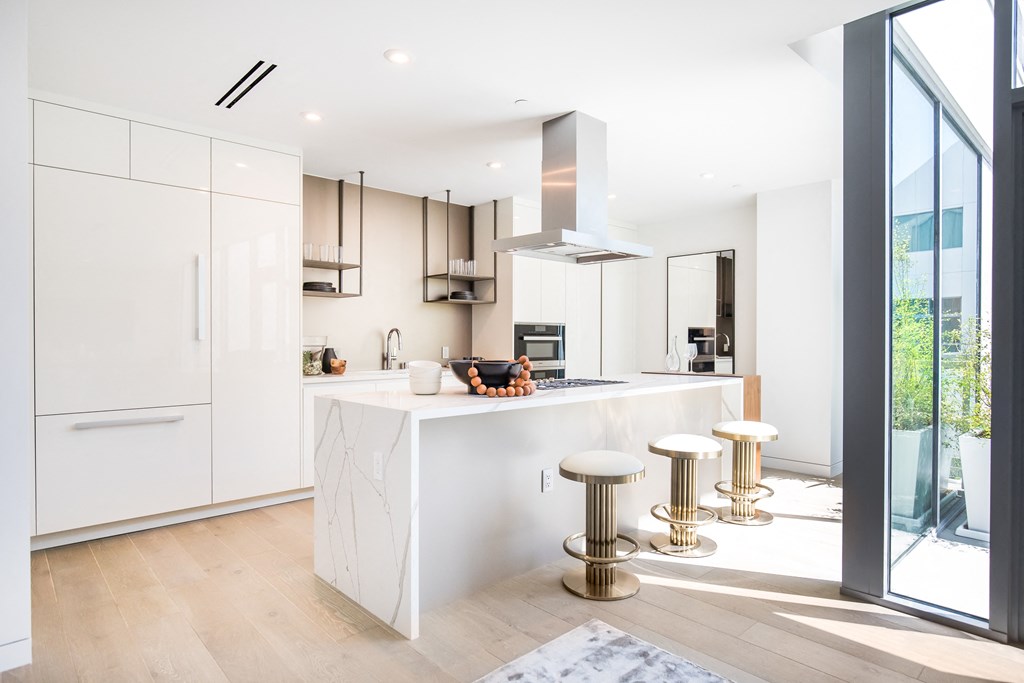 Sleek white kitchen with marble island