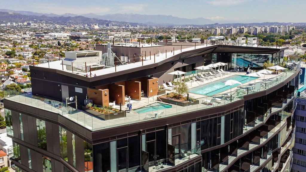 exterior of building and rooftop pool Sentral Beverly Hills apartments