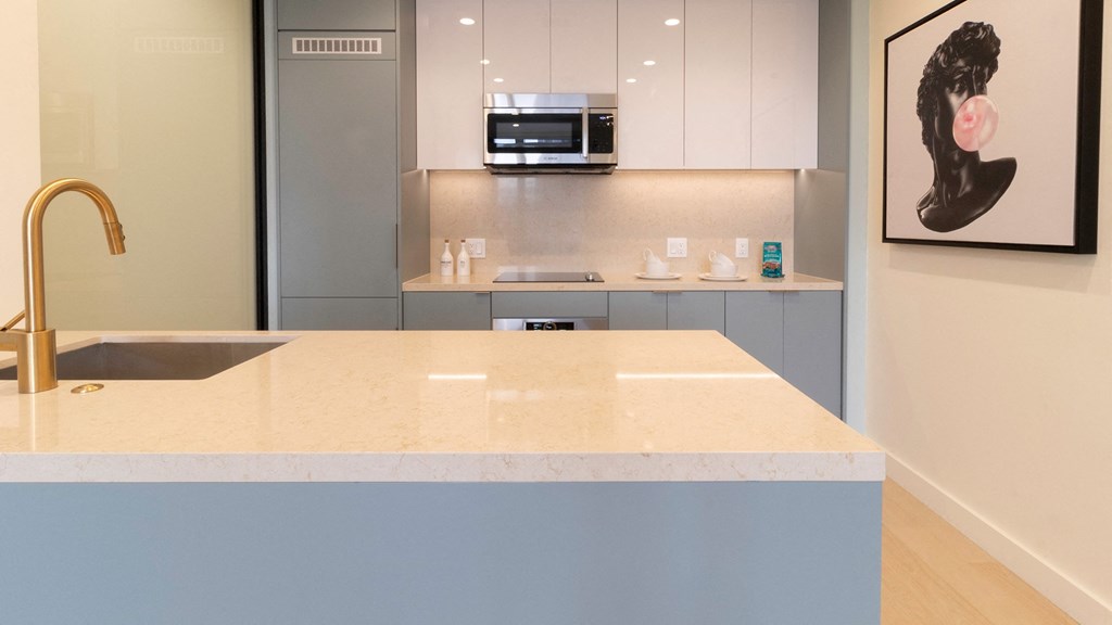kitchen with a large island and a sink Sentral Beverly Hills apartments