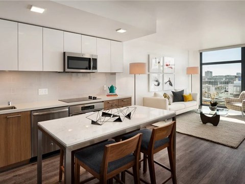 A modern kitchen with a dining table and chairs.