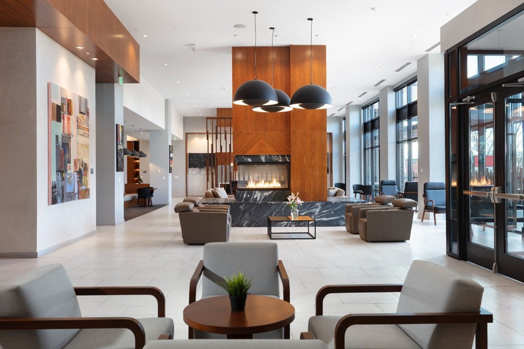 A modern living room with a fireplace and comfortable seating.