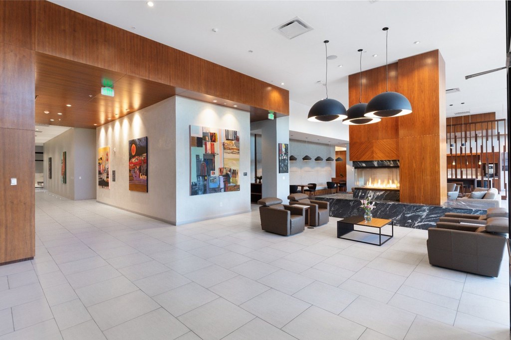 A spacious lobby with a white tile floor and a variety of seating options.