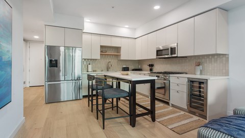 A kitchen with a table and chairs in the middle of it.