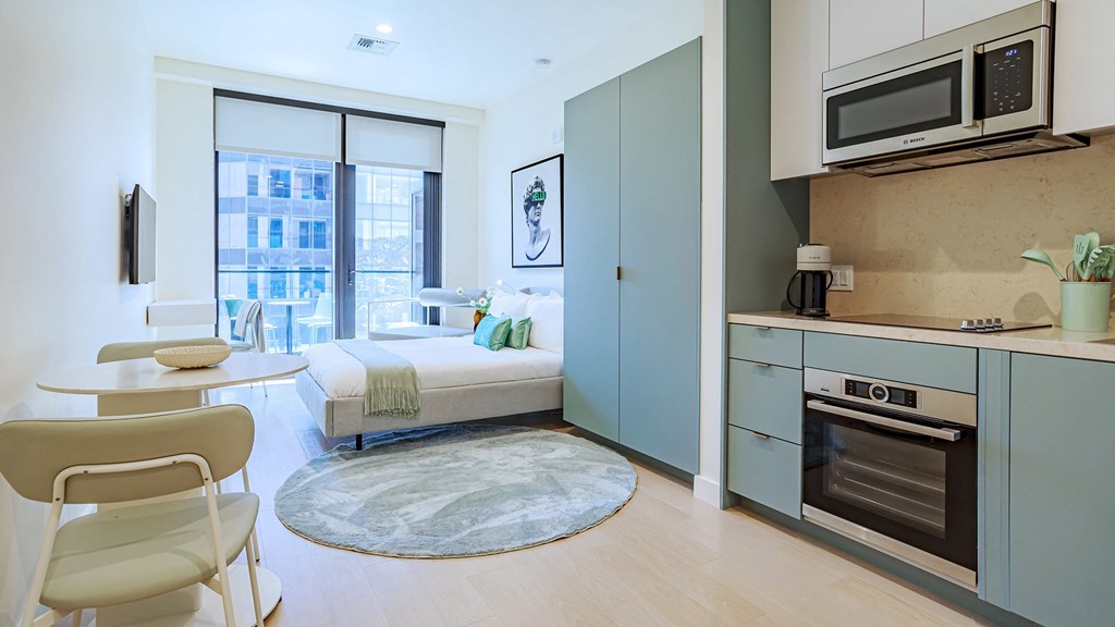 studio living room with kitchen and dining area Sentral Beverly Hills apartments