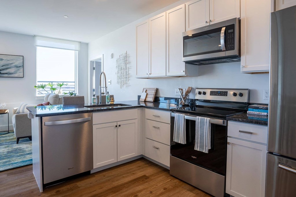 a kitchen with stainless steel appliances and white cabinets