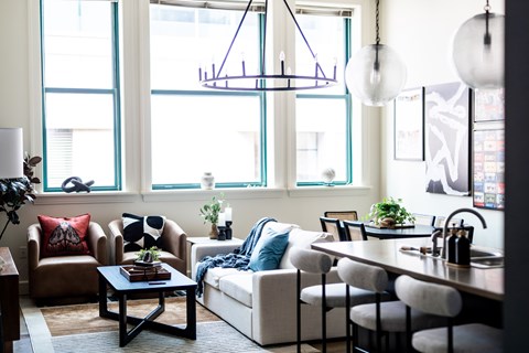 A living room with a brown sofa, a white couch, and a coffee table.
