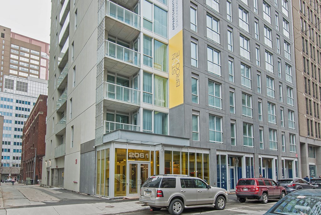 a city street with cars parked in front of a building