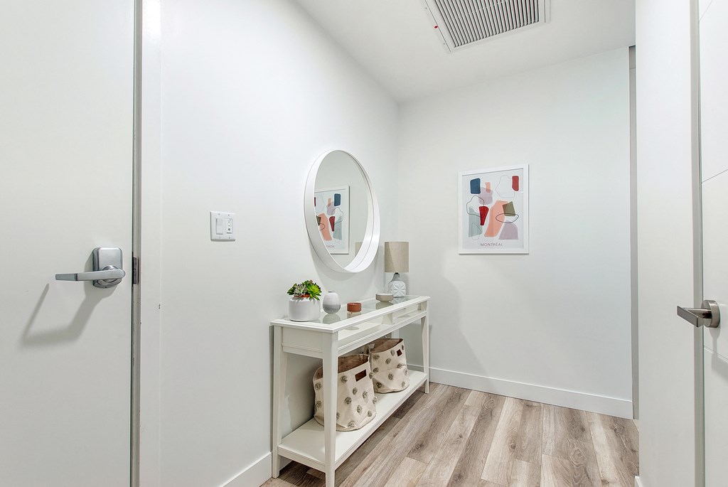 a bathroom with a vanity and a mirror and a glass door