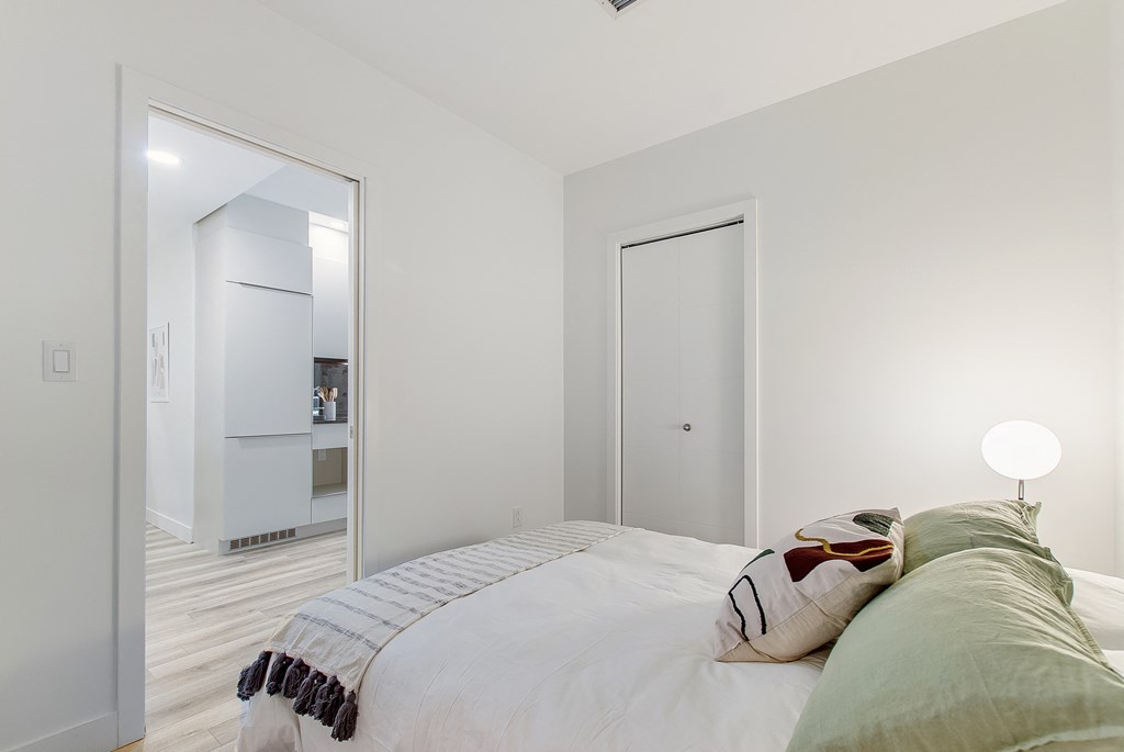 a bedroom with a bed and a mirror