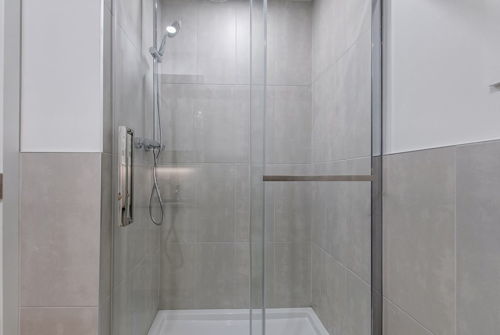 a shower with a glass door in a bathroom