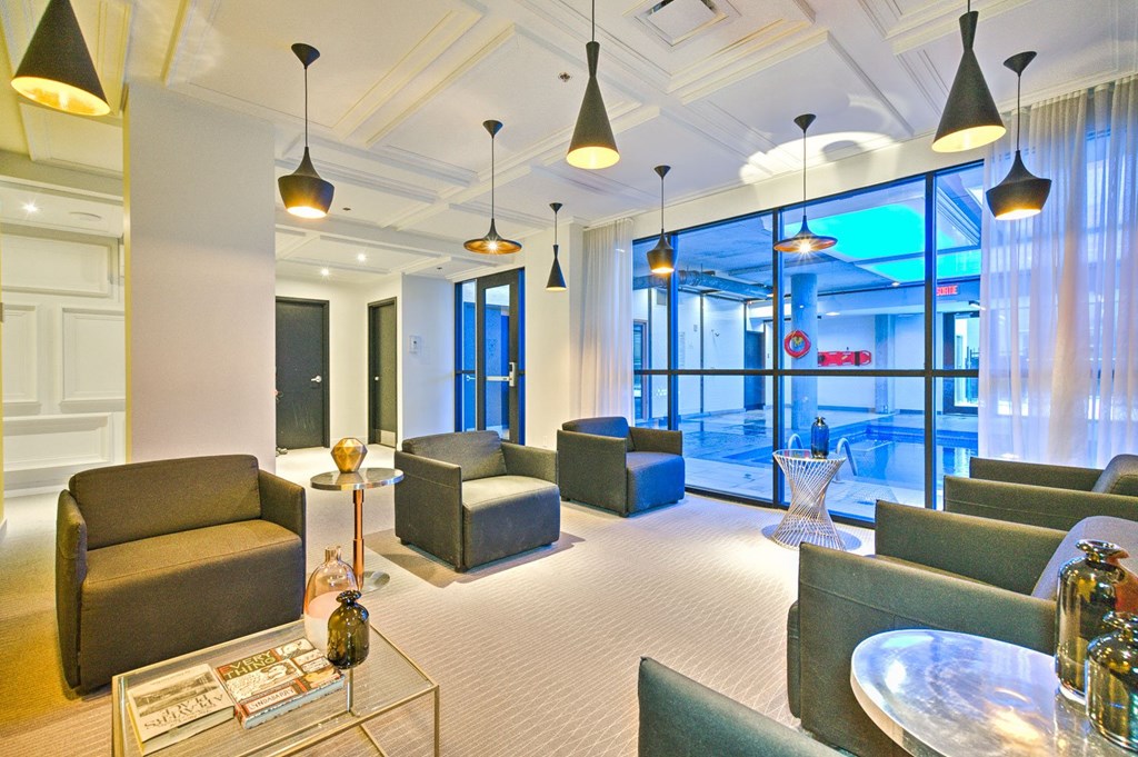A living room with a glass coffee table and a sofa.