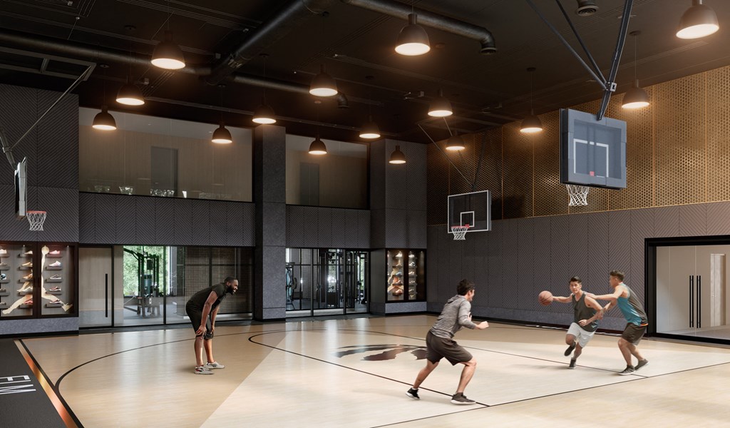 a group of young men playing basketball in a gym