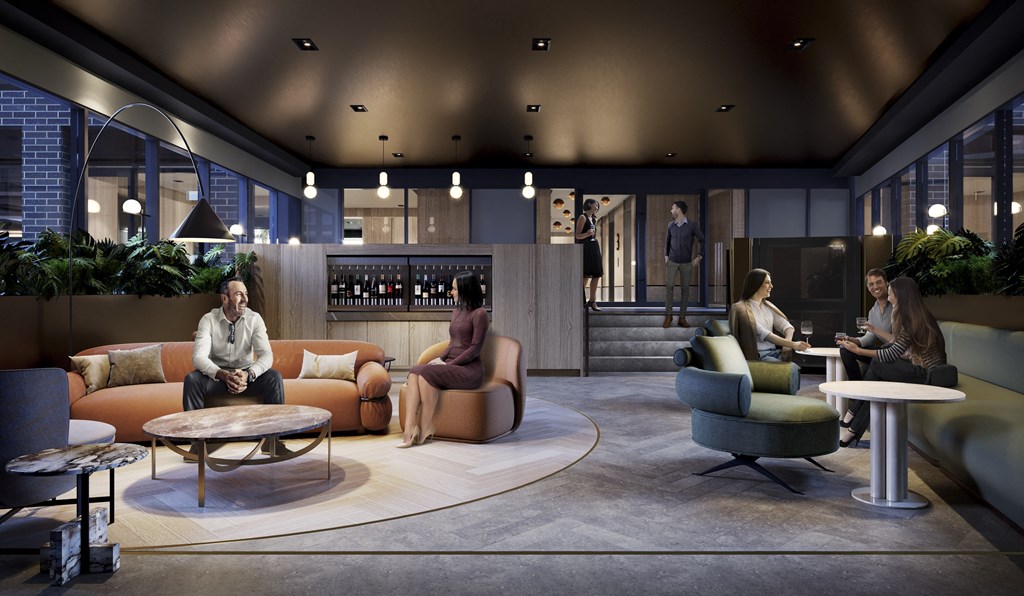 people sitting in a lobby with couches and chairs