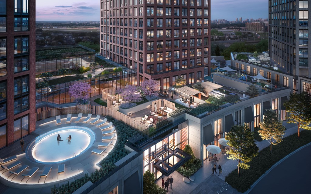 an aerial view of a building with a pool in the middle