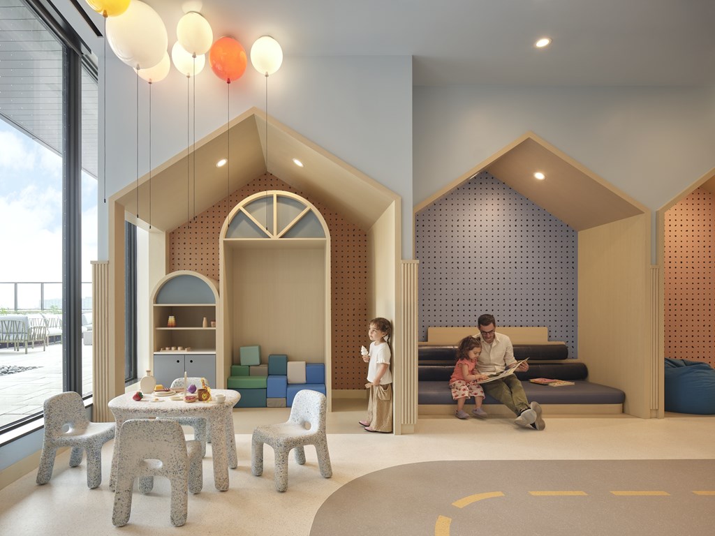 A family is sitting in a room with a blue wall and a dining table with chairs.