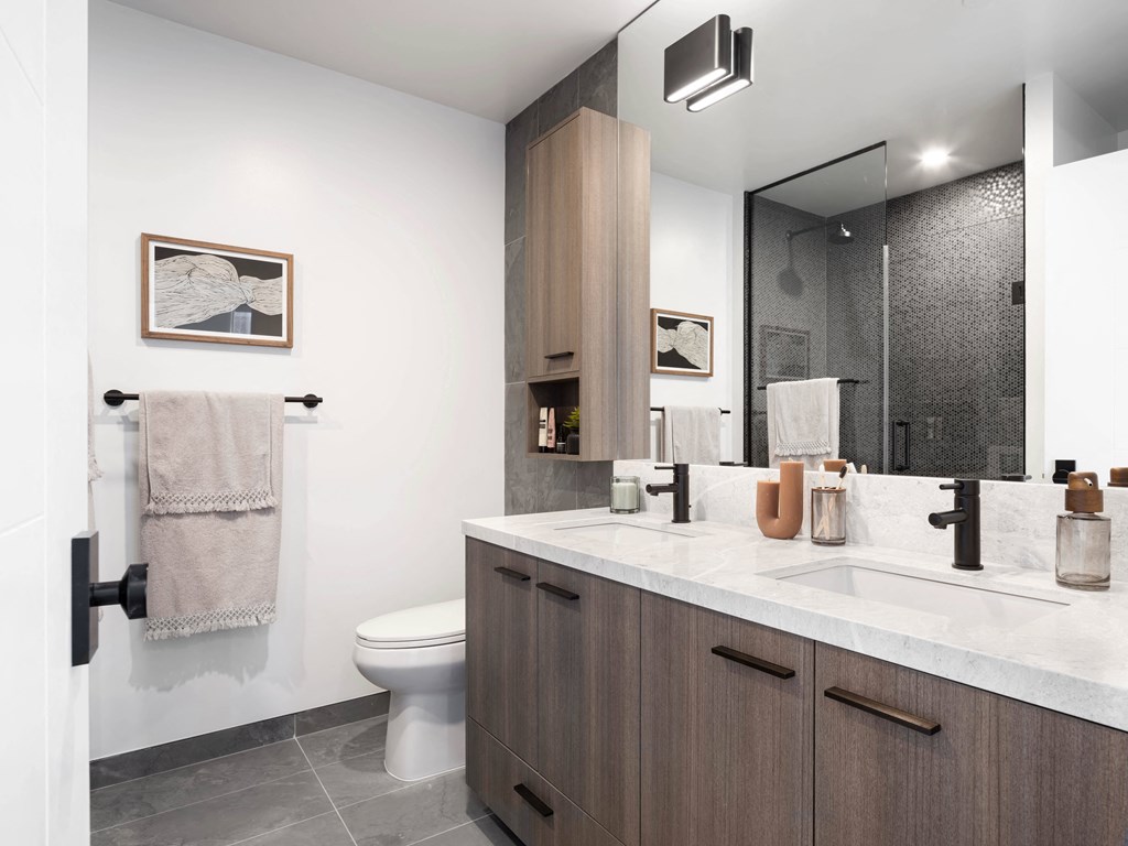 a bathroom with a toilet sink and a mirror