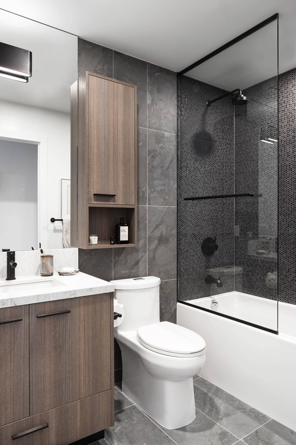 a bathroom with a toilet and a shower and a sink