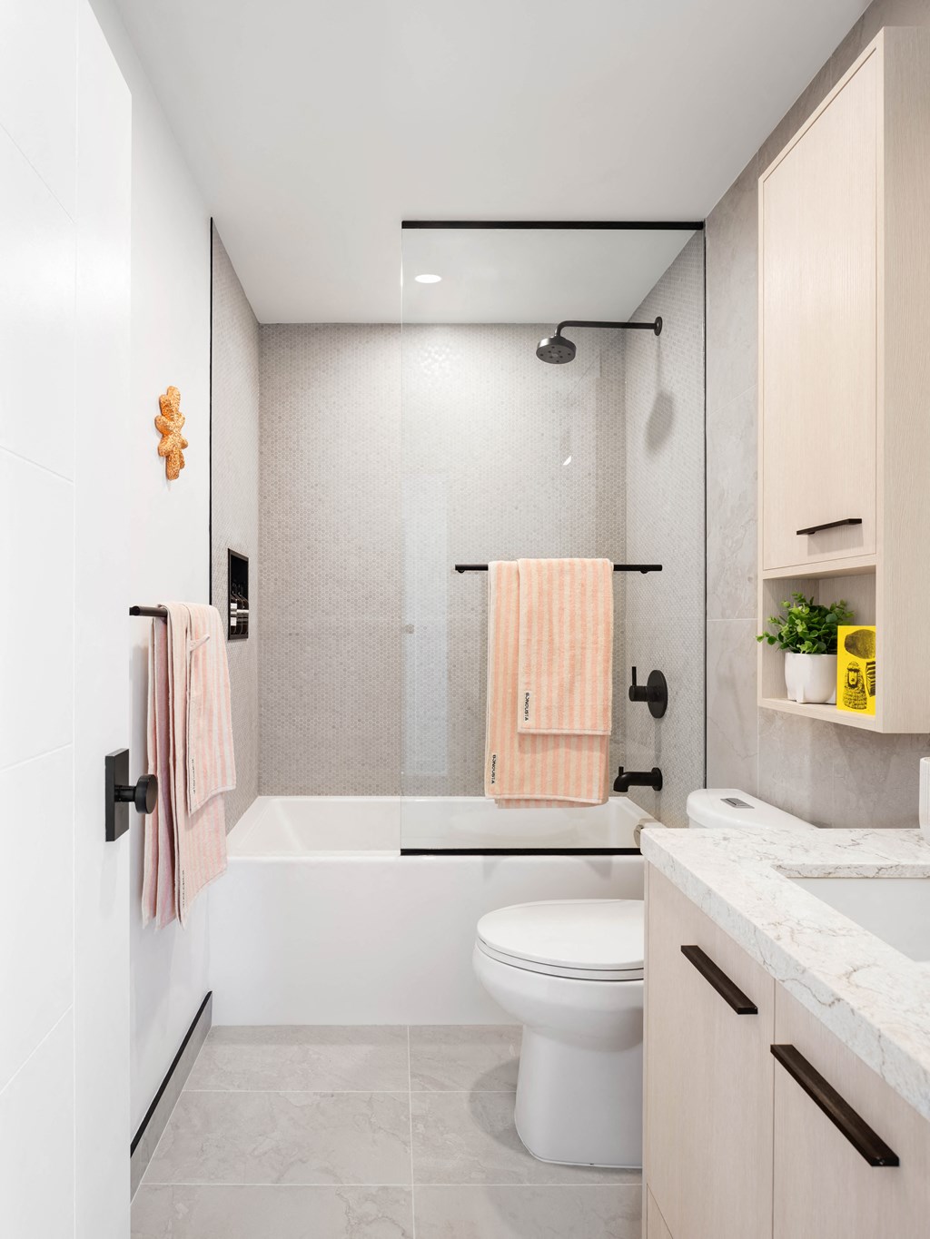 a white bathroom with a shower and a toilet