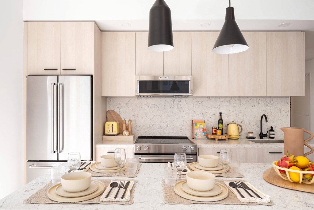 a kitchen with a dining table and a refrigerator