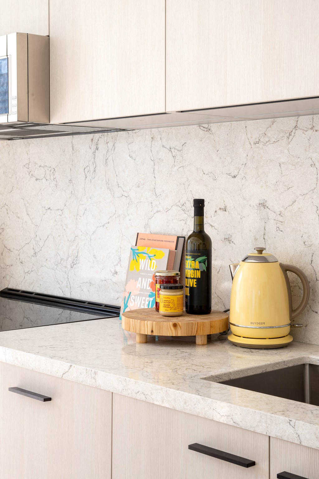 a kitchen counter with a bottle of wine and some food on it