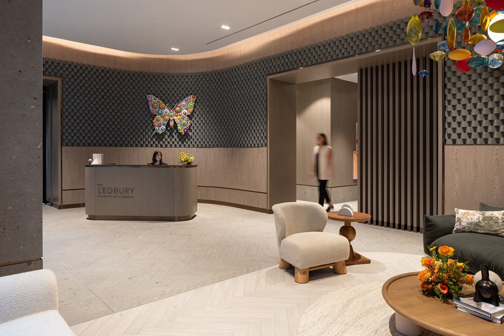 a lobby of a hotel with a reception desk and