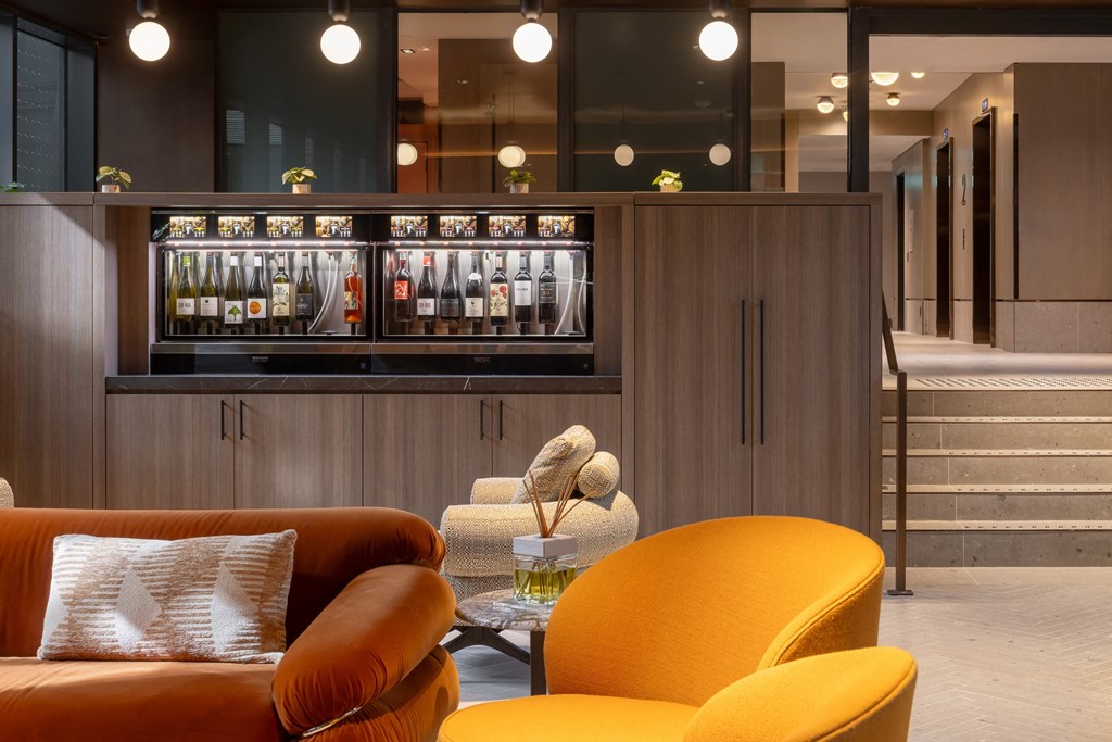 the lobby of a hotel with couches and a bar