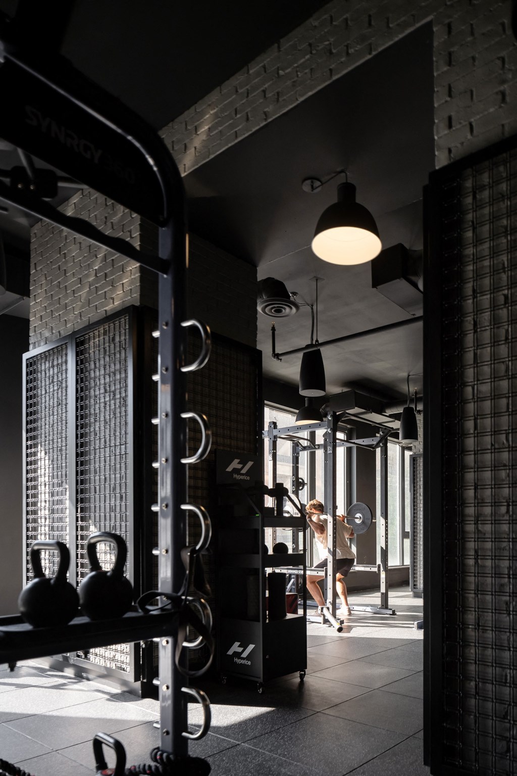 a woman running in a gym with a workout machine