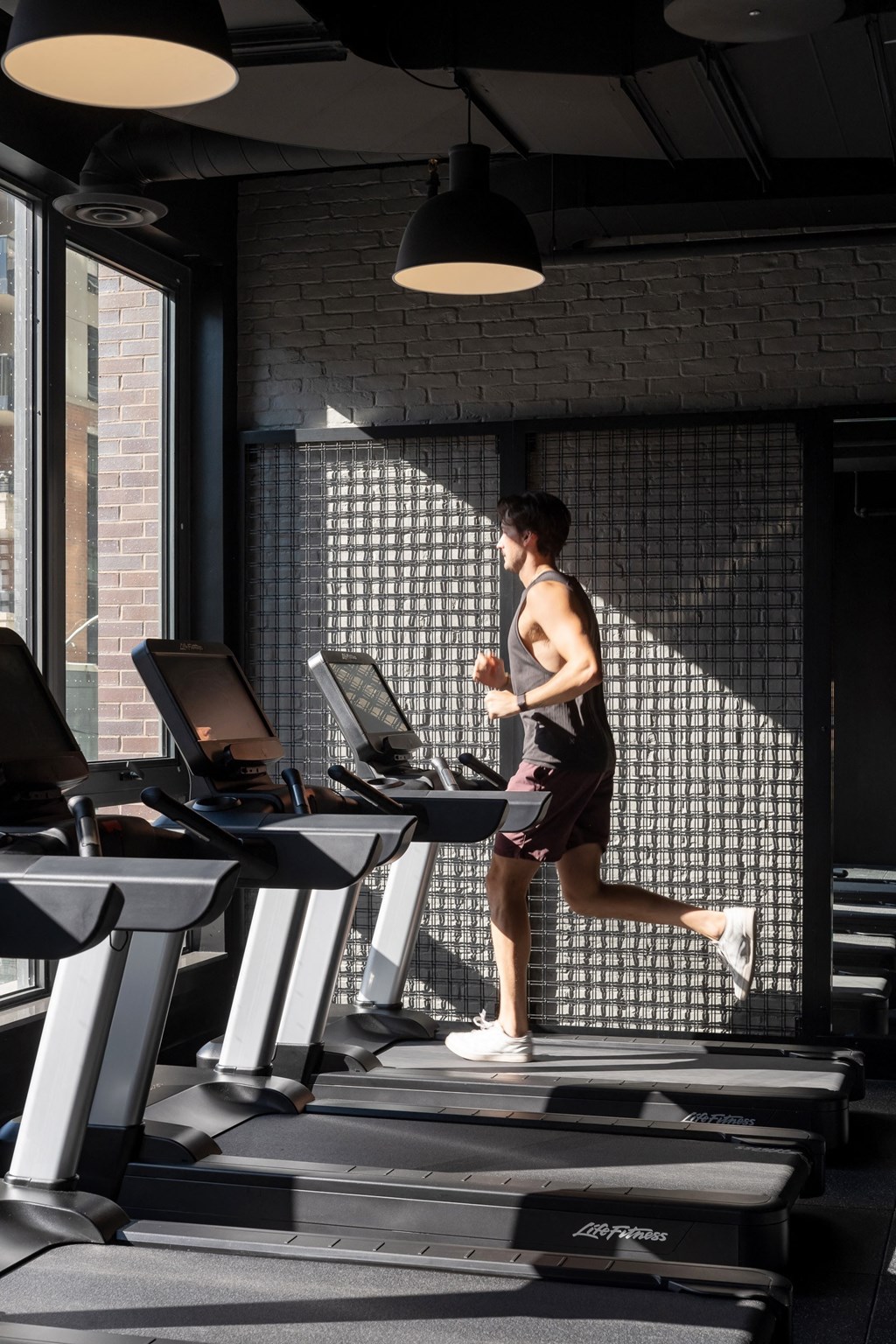 a man running on a treadmill in a gym