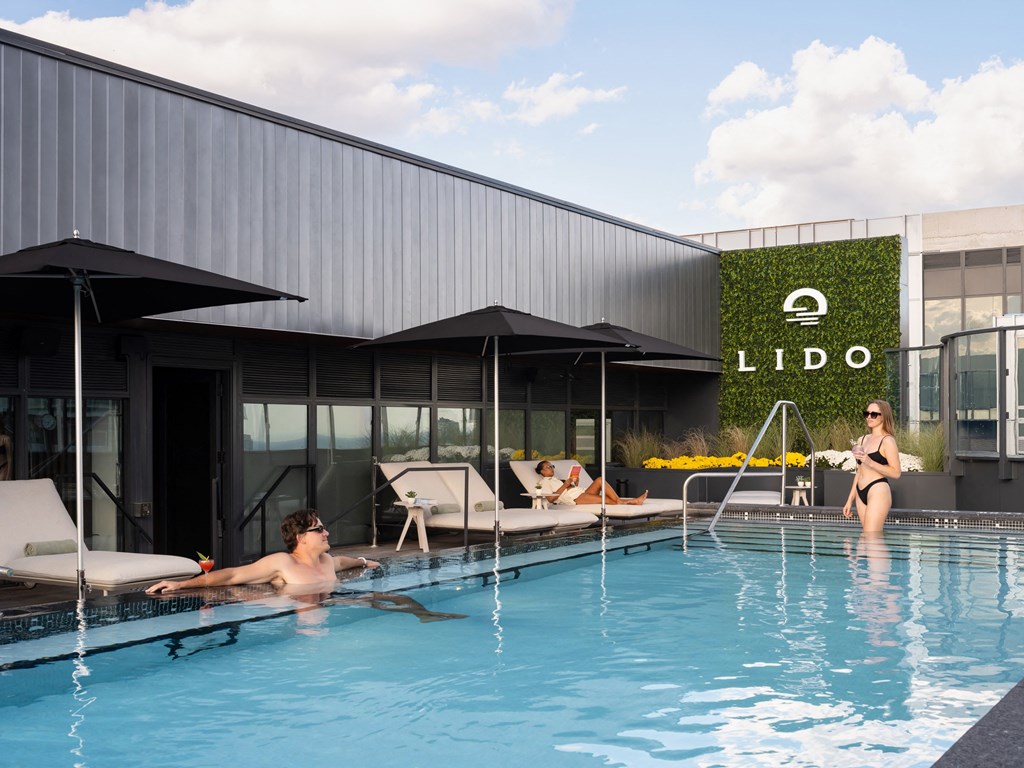 a group of people in a swimming pool in front of a building