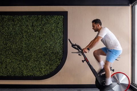 a man riding an exercise bike in a gym