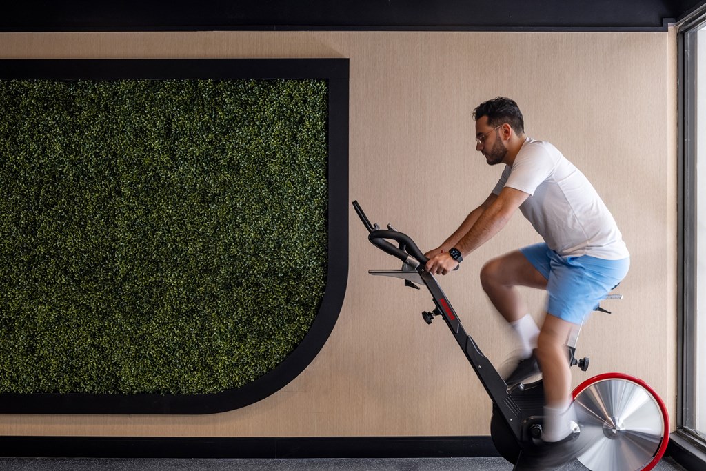 a man riding an exercise bike in a gym