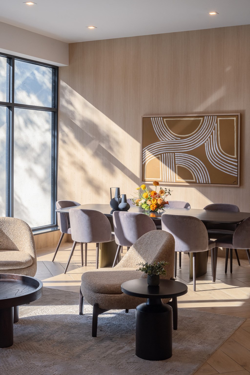 a dining room with a table and chairs and a painting on the wall