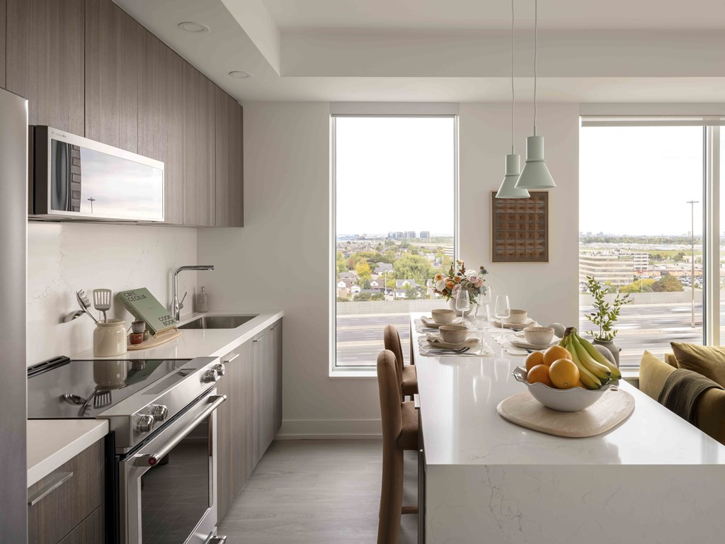 A modern kitchen with a dining table set for two.