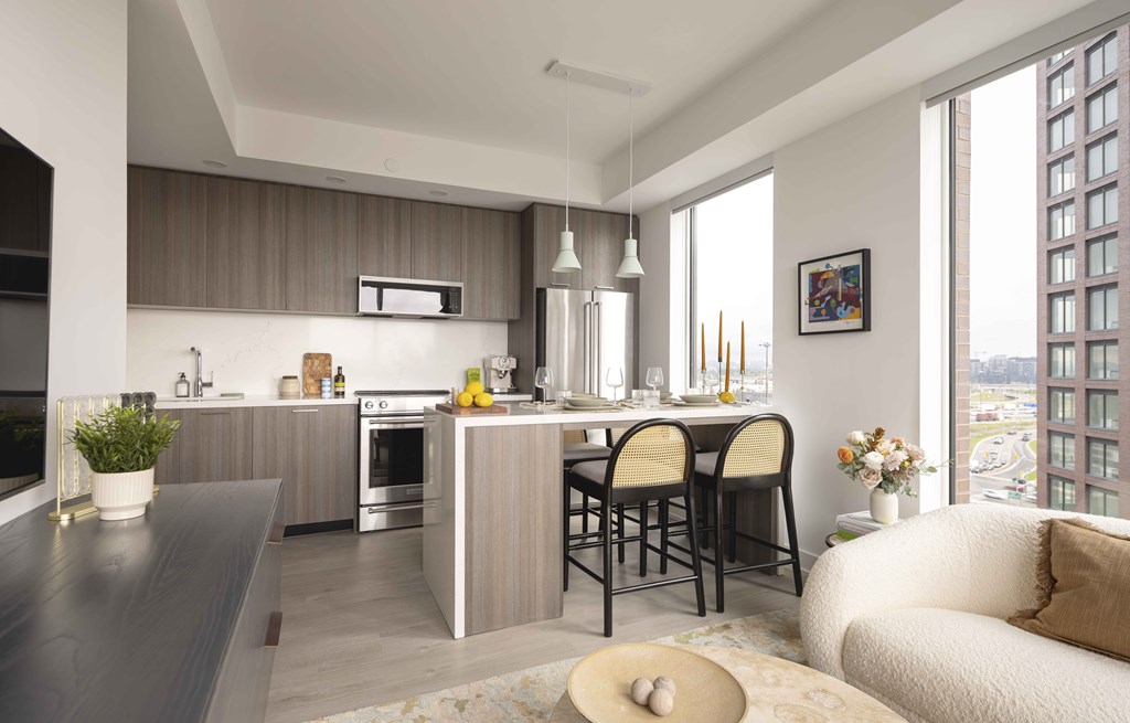 A modern kitchen with a dining table and chairs.